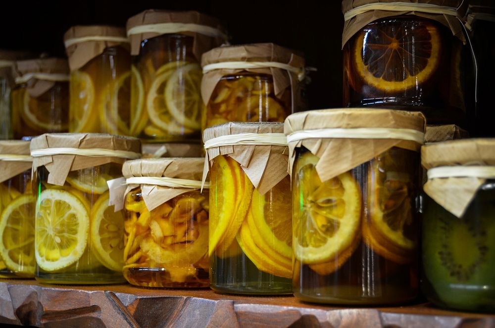Preserved lemons in jars on rack. Free public domain CC0 image.  