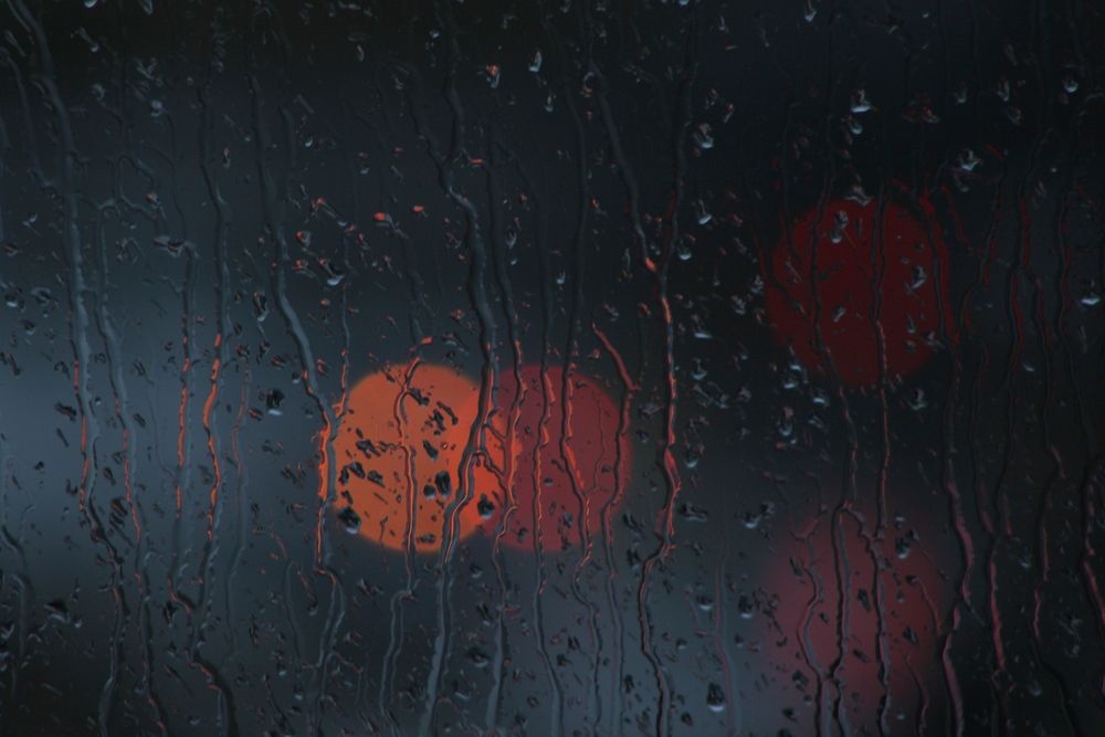 Rain on glass with bokeh. Free public domain CC0 photo.