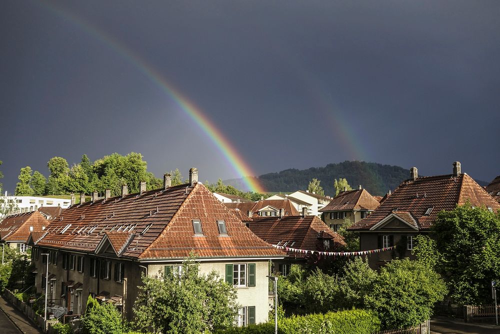 Rainbow over houses. Free public domain CC0 image.