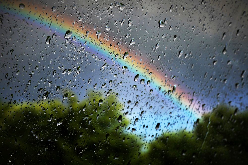 Rainbow through raindrops window. Free public domain CC0 image.