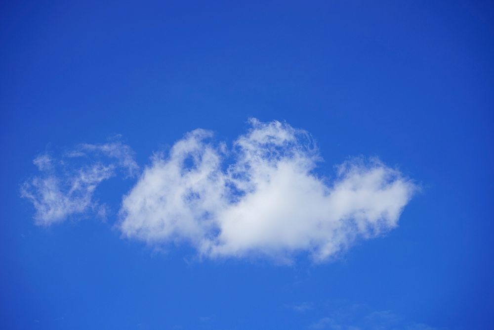 Blue sky background with clouds. Free public domain CC0 photo.