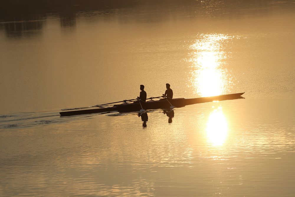 People canoeing in sunset. Free public domain CC0 photo.