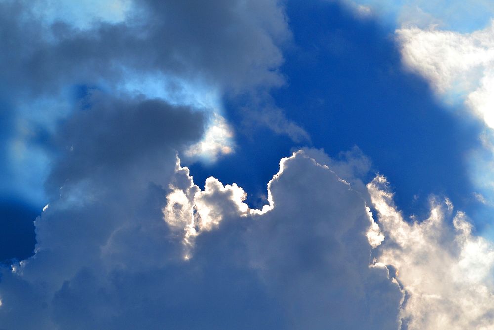 Blue sky background with clouds. Free public domain CC0 photo.