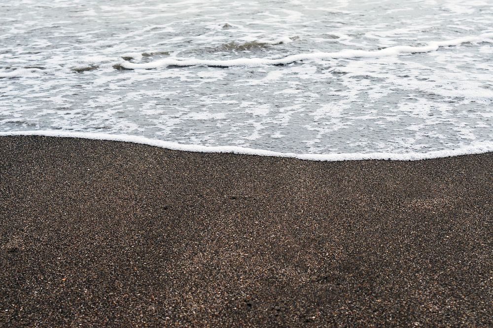 Waves crashing into black sand. Free public domain CC0 image.