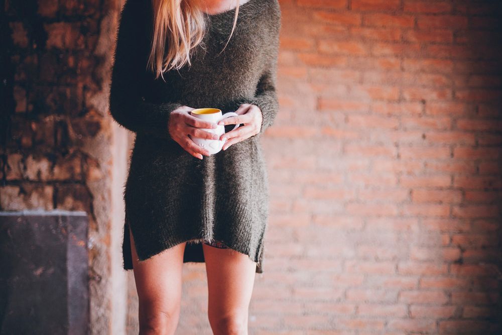 Free woman stands and hold white cup image, public domain people CC0 photo.