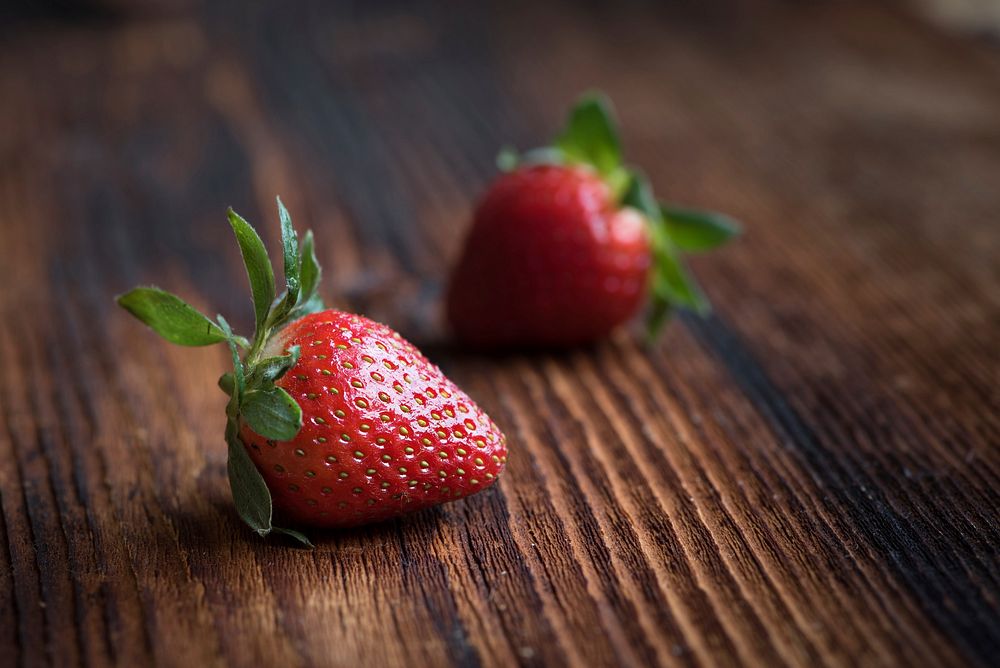 Fresh strawberries on wooden table. Free public domain CC0 image.