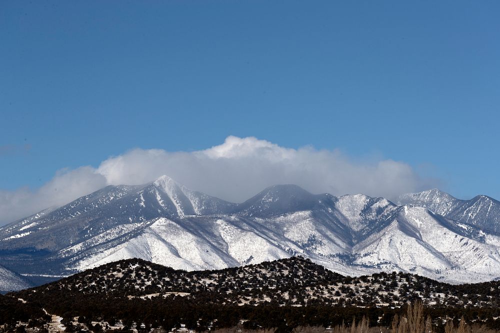Powdered-sugar-like snow covers the San Francisco mountain range outside Winona, Arizona. Original image from Carol M.…