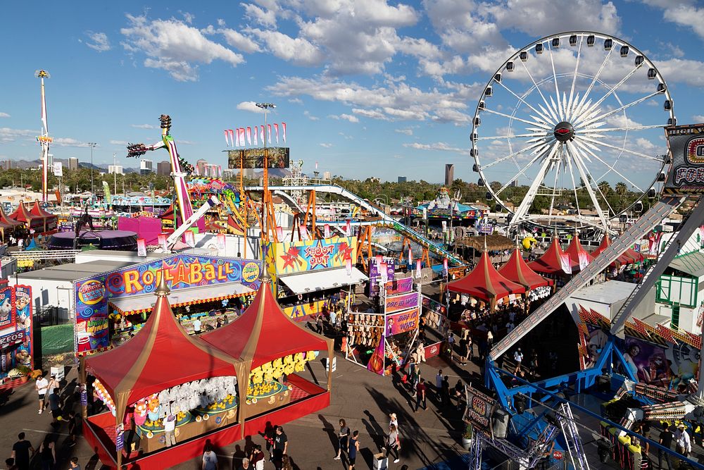 Carnival rides and games, including a Ferris wheel, in Phoenix at the annual Arizona State Fair, which has been held since…