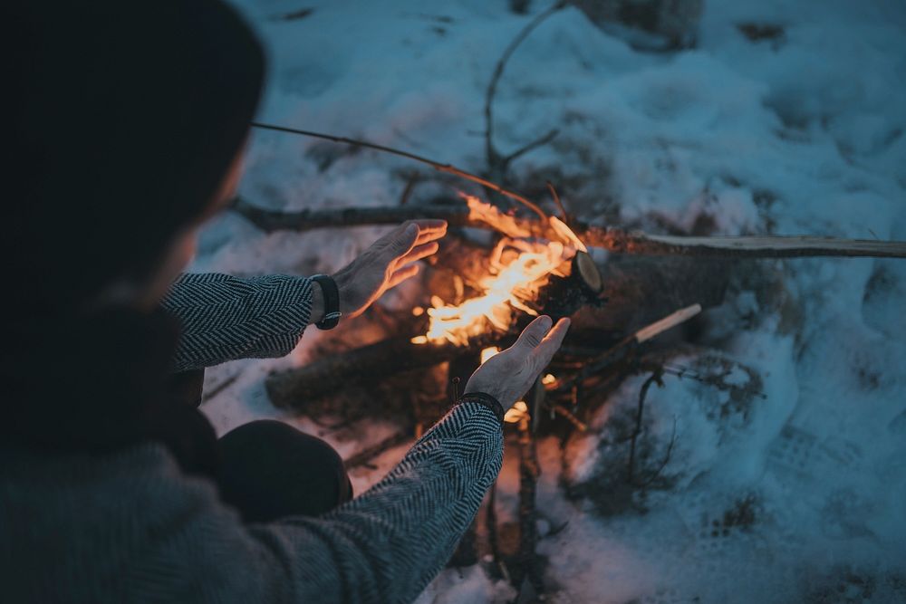 Free person warming at camp fire photo, public domain nature CC0 image.