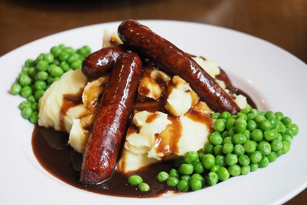 Free sausage and mash, peas in white plate photo, public domain food CC0 image.