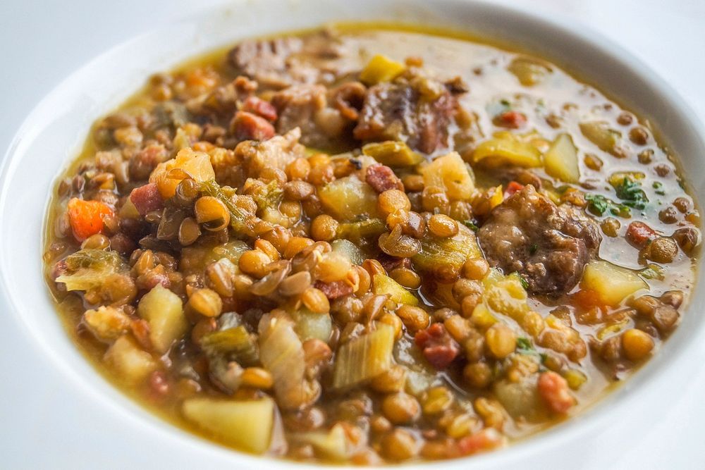 Fresh creamy lentil soup, white plate photo, public domain food CC0 image.