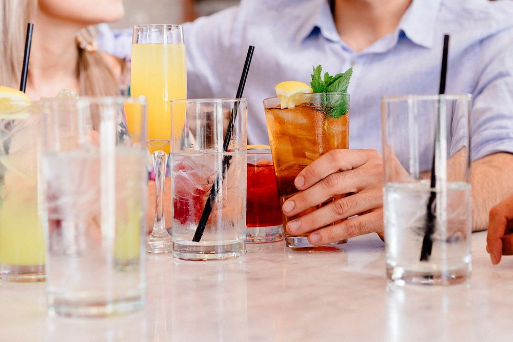 Free cocktails on table with people background photo, public domain beverage CC0 image.