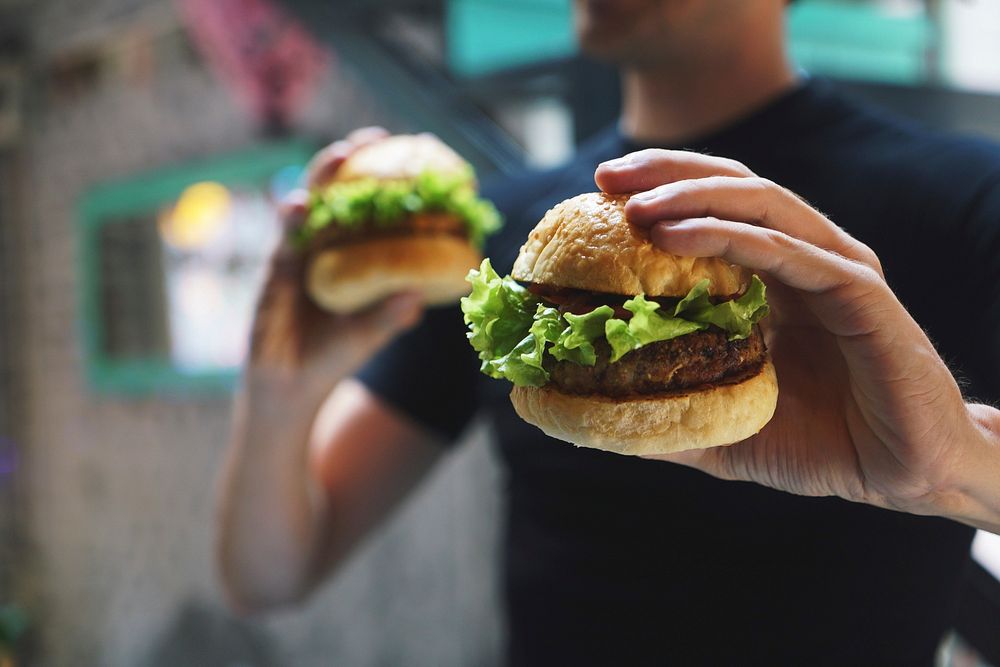 Free hands holding burger image, public domain food CC0 photo.