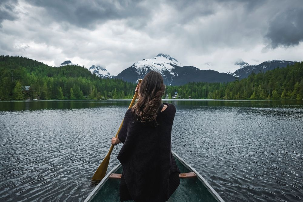 Free woman paddling a boat with beautiful view image, public domain CC0 photo.