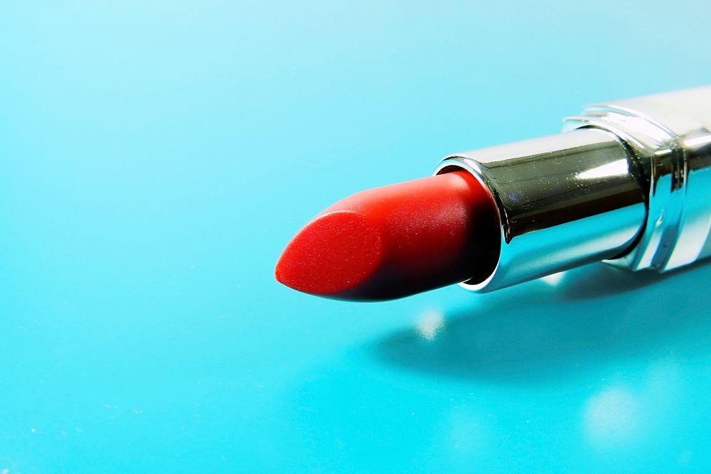 Red lipstick in blue background, free public domain CC0 photo.