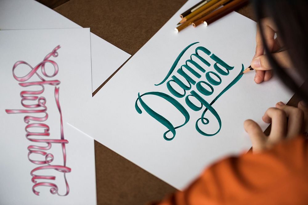An artist creating hand lettering artwork
