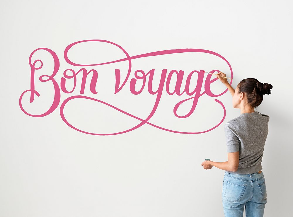 Artist woman writing Bon Voyage on the wall