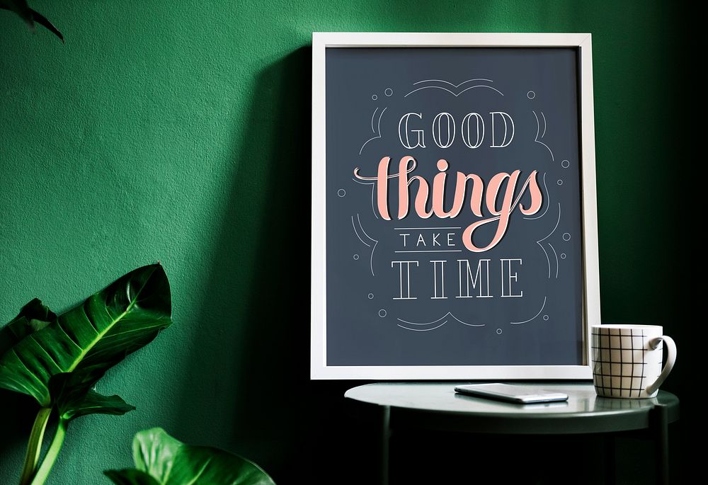 A motivation typography print on the desk against the green wall