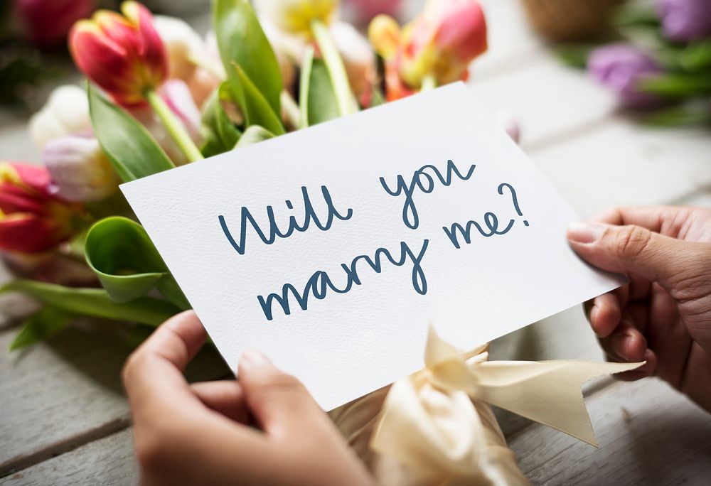 Bouquet of flowers with a "Will you marry me?" card