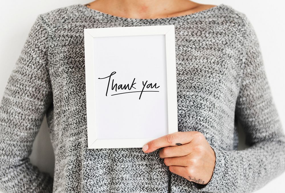 Woman holding a Thank You card
