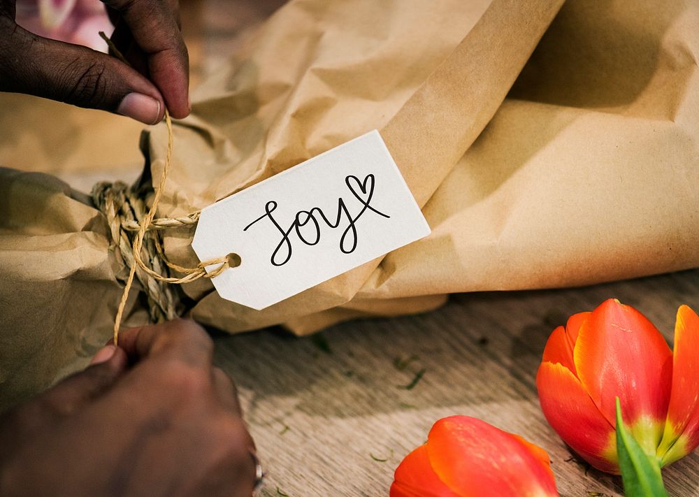Text Joy on a tag of a flower bouquet