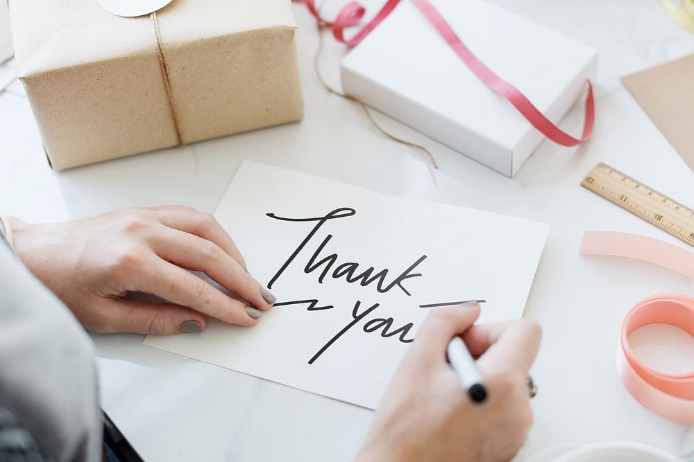 Woman writing a Thank You card