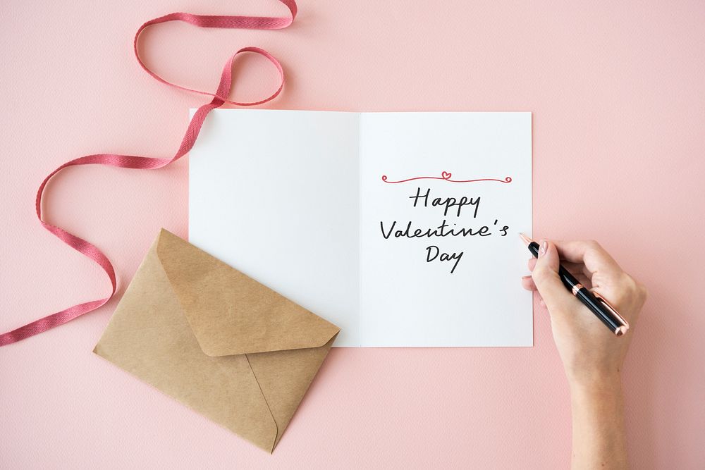 Woman writing a Happy Valentine's Day card