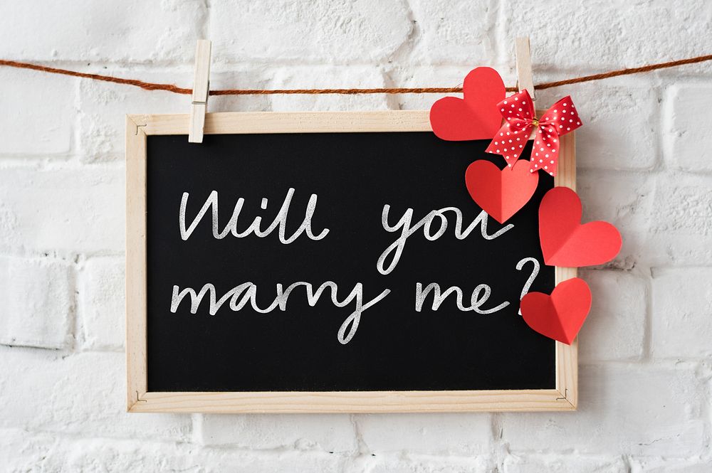 Marriage proposal written on a blackboard