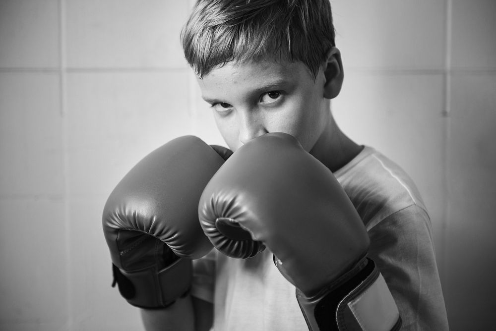 Tough young boy in a boxing pose