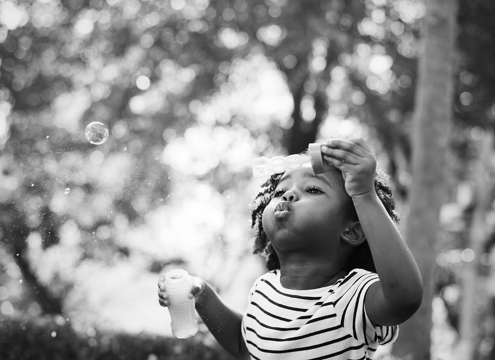 African kid playing with bubbles