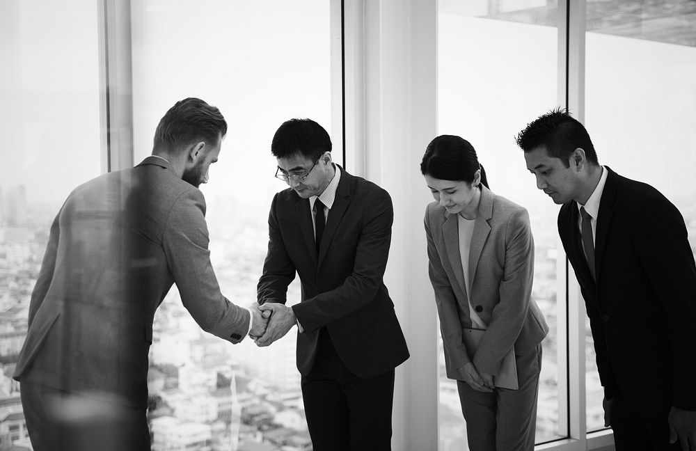 Japanese business people having a handshake with a colleague