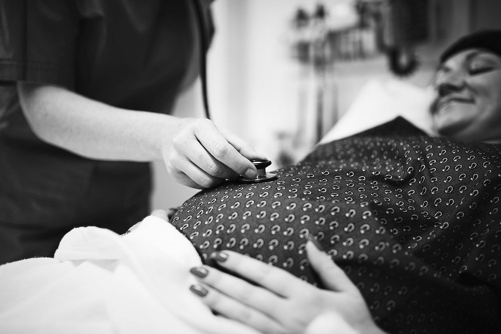 A trimester pregnant woman getting a checkup
