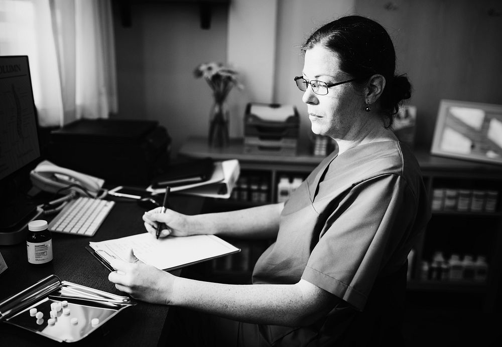 Female doctor writing a prescription