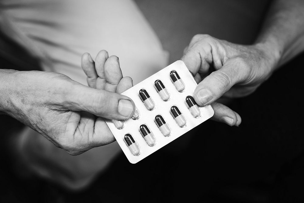 Hands holding medication capsules