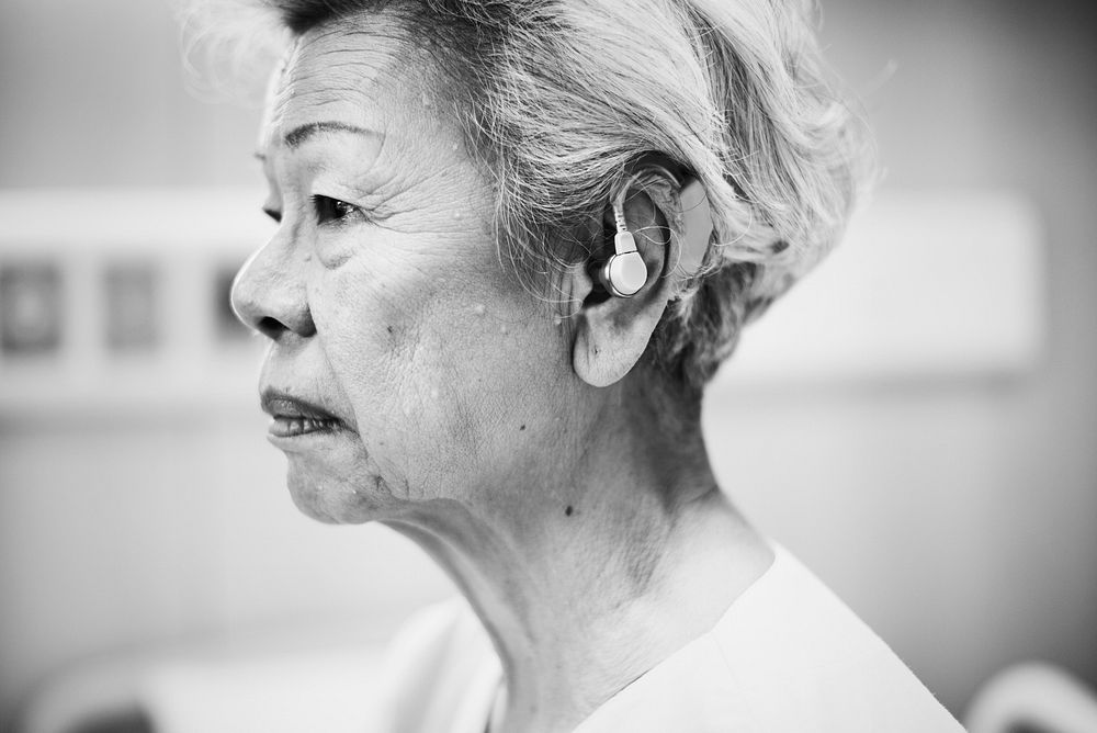 An elderly woman with hearing aids