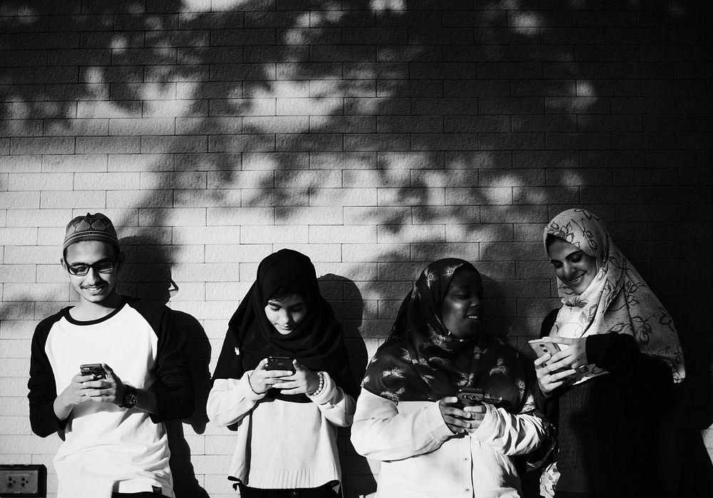 A group of Muslim students using mobile phones