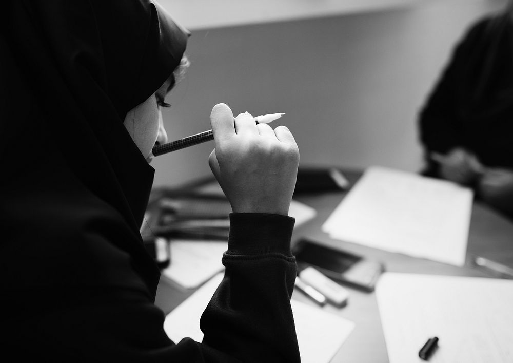 Young Muslim students learning in class