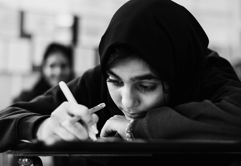 Young Muslim student studying in a classroom