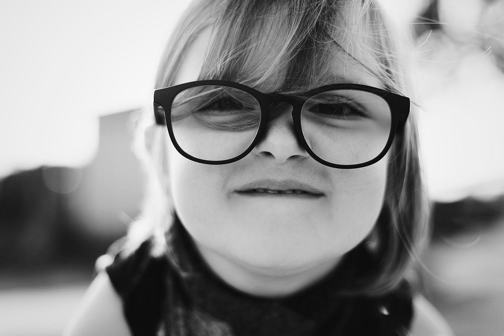Cheerful pretty little girl with glasses