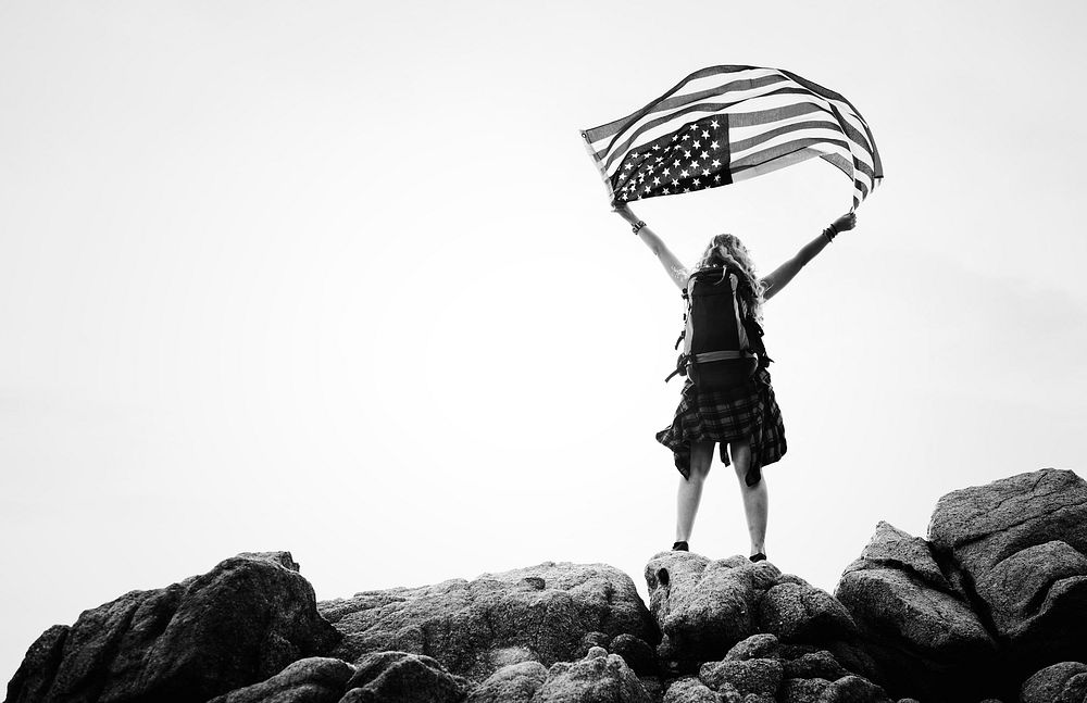 Caucasian woman holding an American flag
