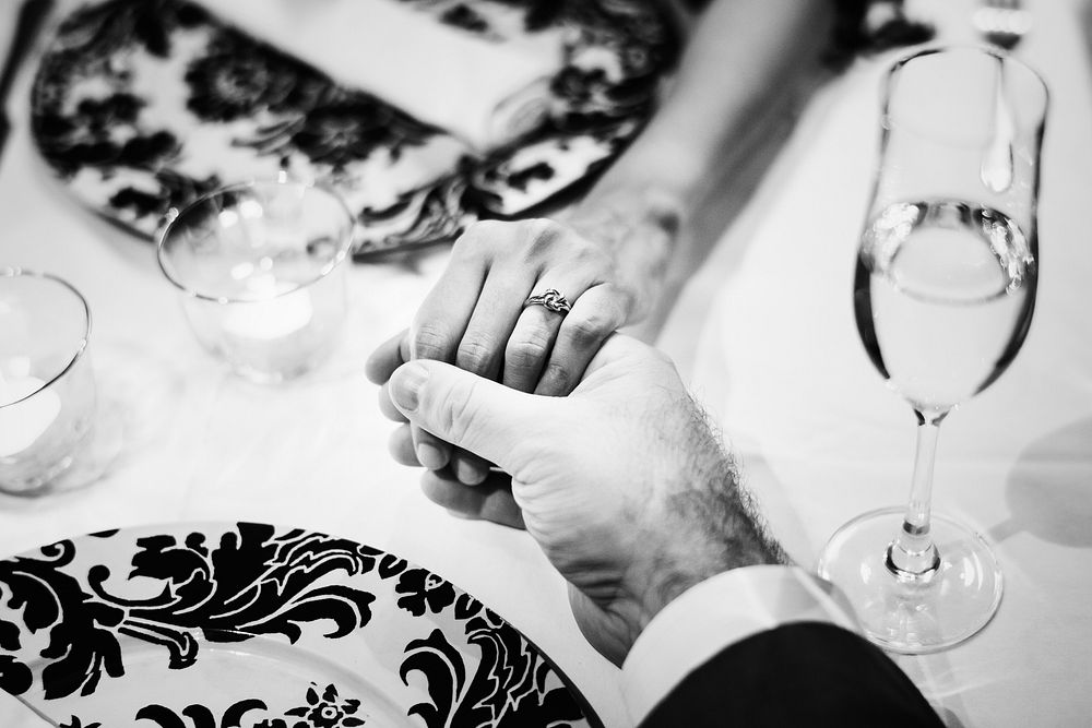 Couple holding hands at a romantic dinner