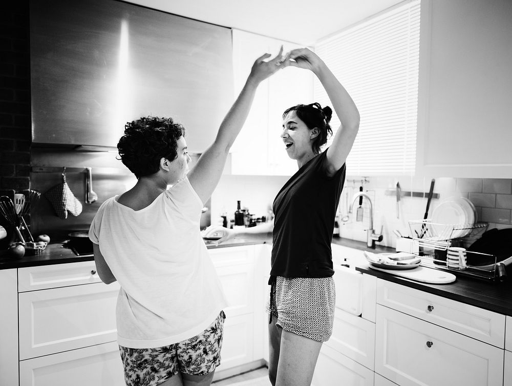 Lesbian couple dancing in the kitchen