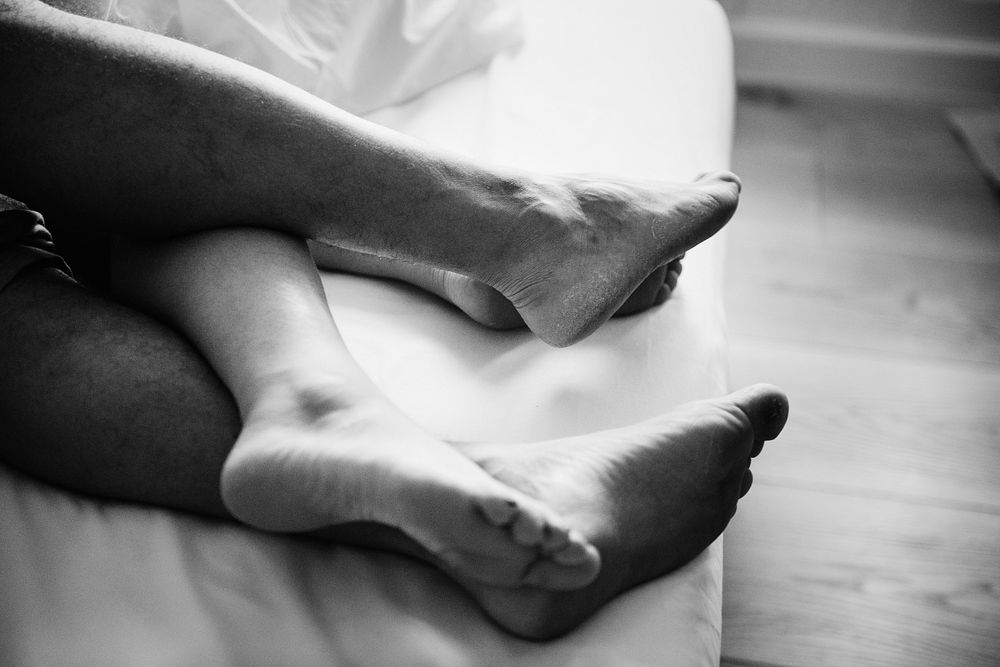 Legs of a couple sleeping in bed