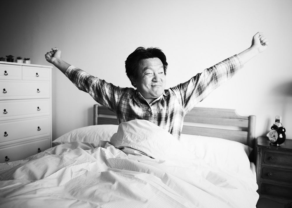 A man waking up on the bed