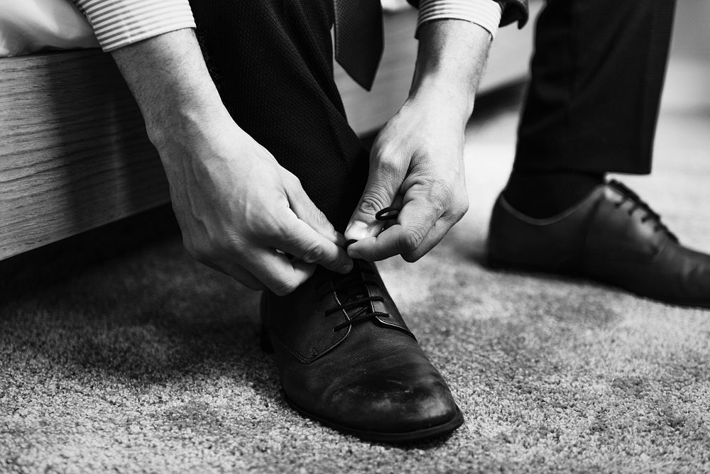A man tying shoe laces