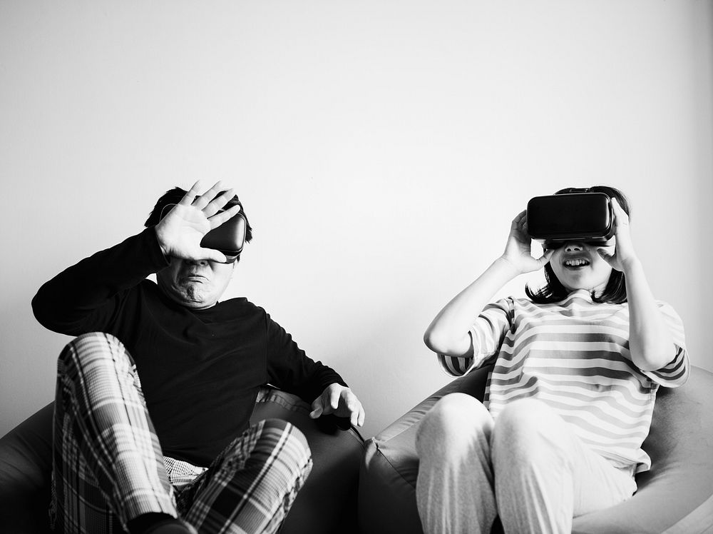 Asian couple experiencing virtual reality with VR headset