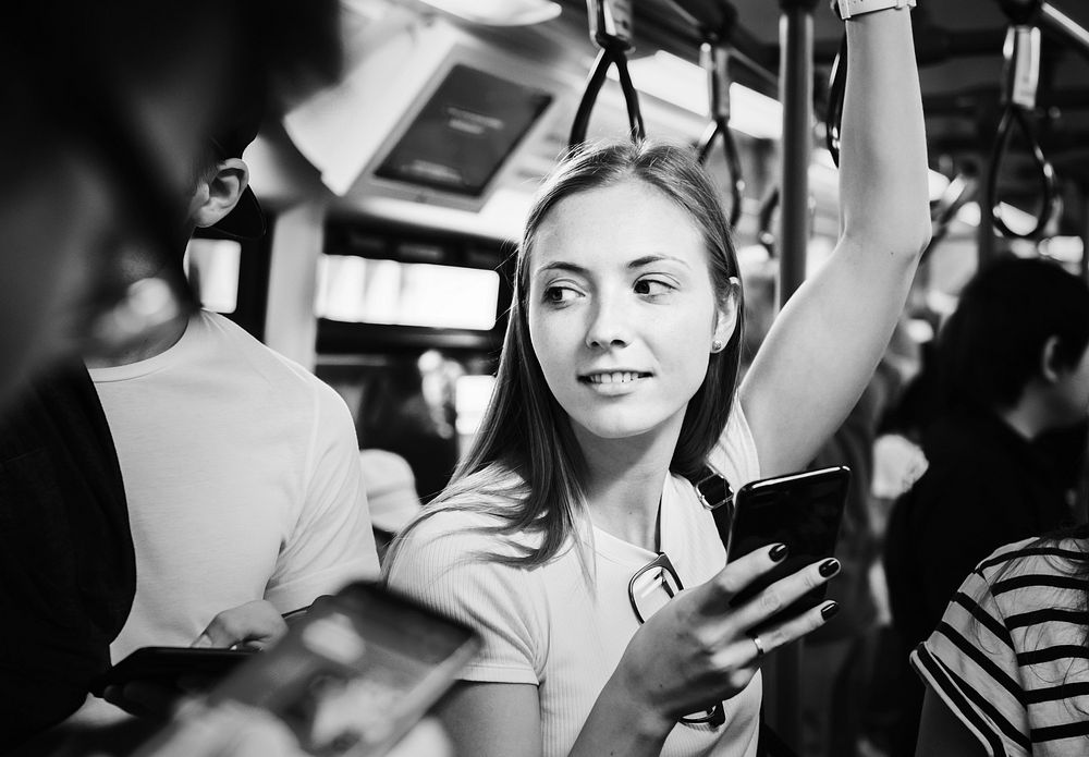 Young woman using a smartphone in the subway