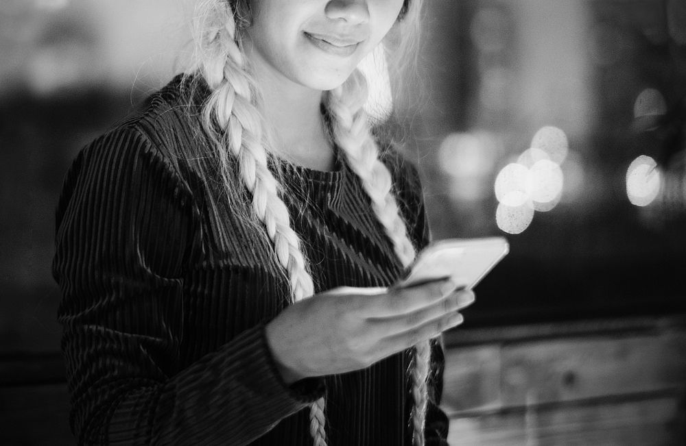 Smiling young woman using a smartphone