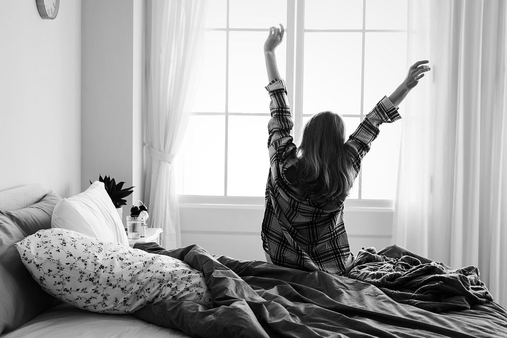 Rear view of woman stretching her arms in the morning