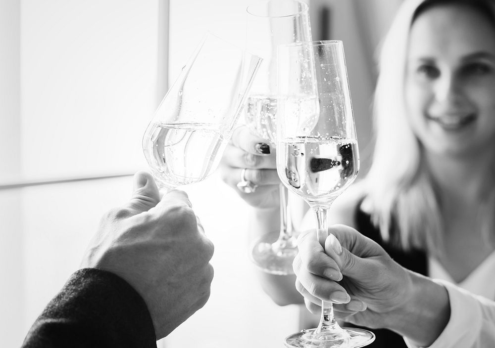 Closeup of people clinking wine glasses